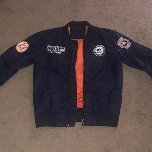I’m selling a navy blue jacket, orange on the inside with white designed letter